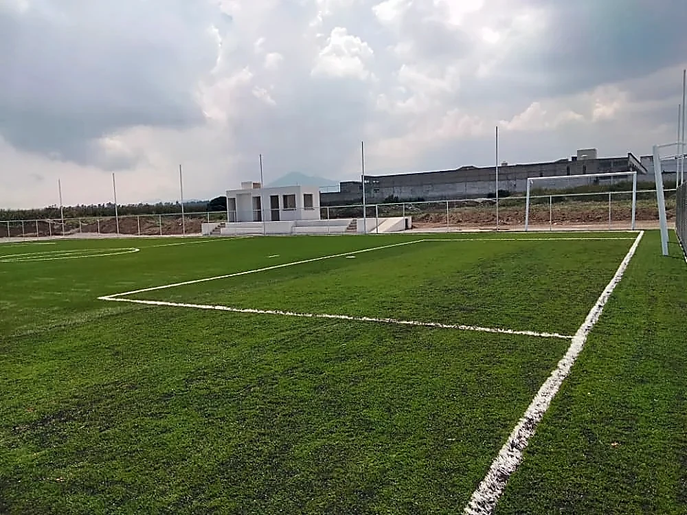 Cancha de fútbol 7 con pasto sintético en Calimaya, Estado de México: la cancha desde la línea lateral