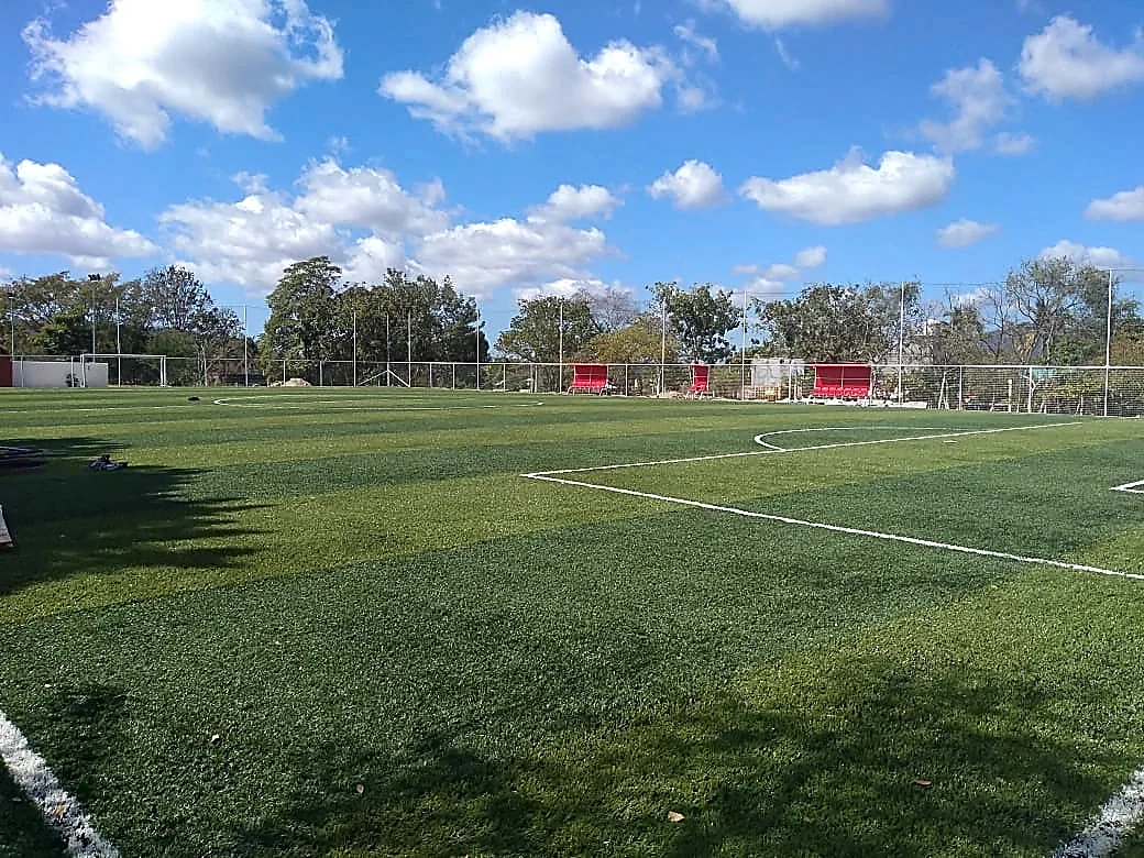 Cancha de fútbol 7 con pasto sintético en Unidad Deportiva Santa Maria Huatulco, Oaxaca: líneas de juego insertadas en el mismo pasto