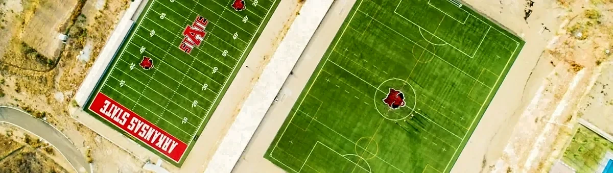 Vista aérea del campo de americano y la cancha de soccer con pasto sintético en Arkansas State University, Querétaro